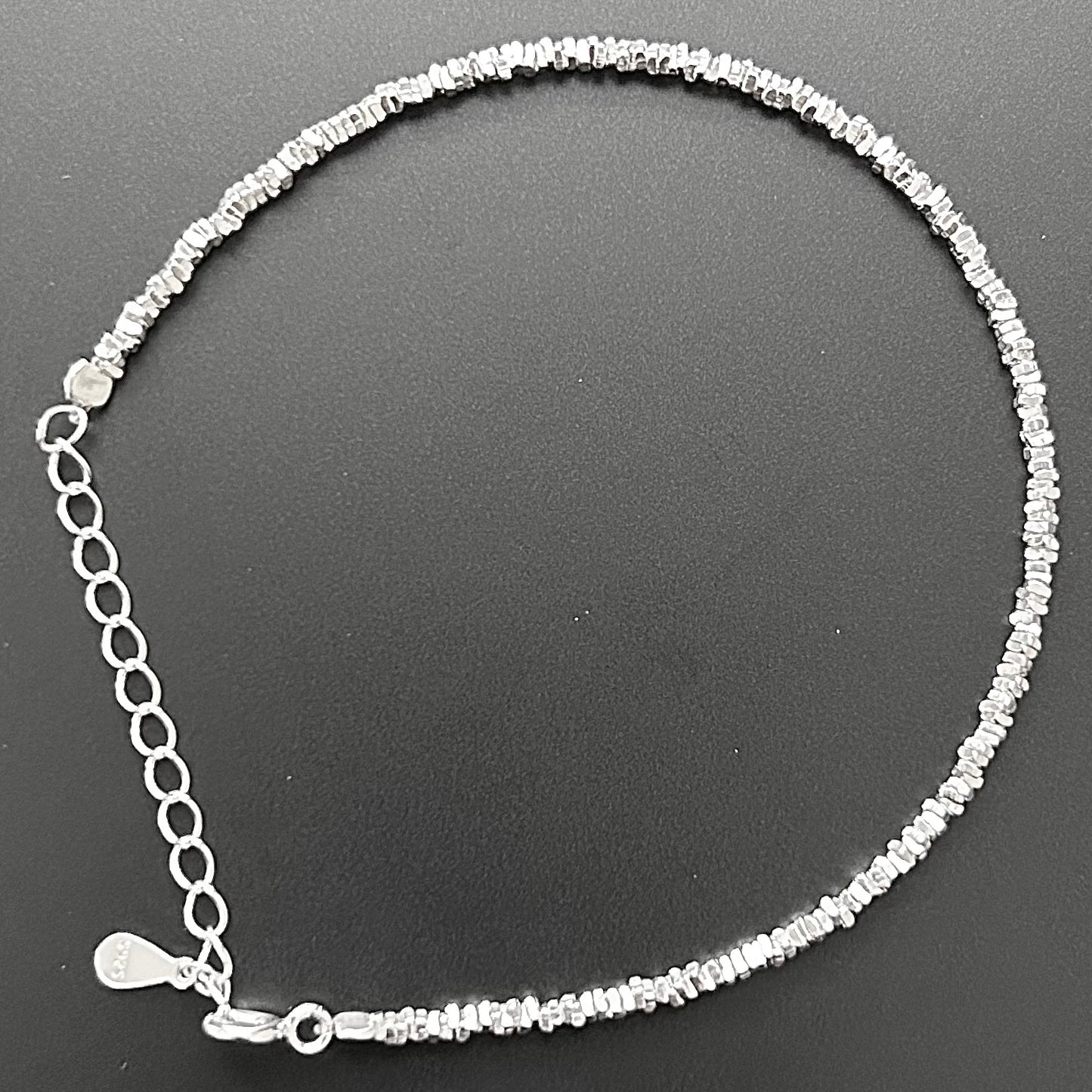 Freya Canada’s I AM ASTERIA Starlight Sterling silver beaded bracelet lying flat on a black background