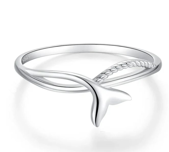 A ring in sterling silver with a fish tail design, water wave and carved rope design on a white background