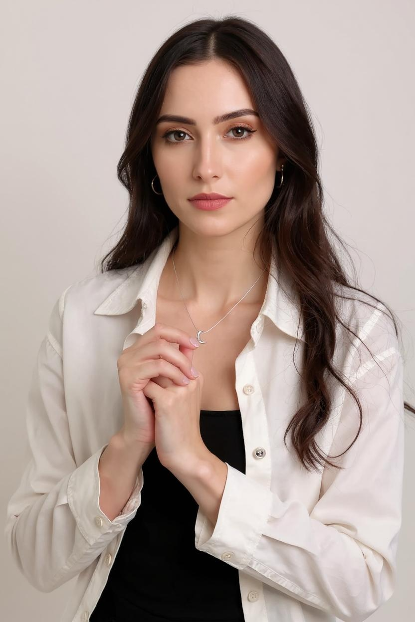 Model is wearing Freya Canada’s I AM SELENE sterling silver luminous crescent moon necklace.