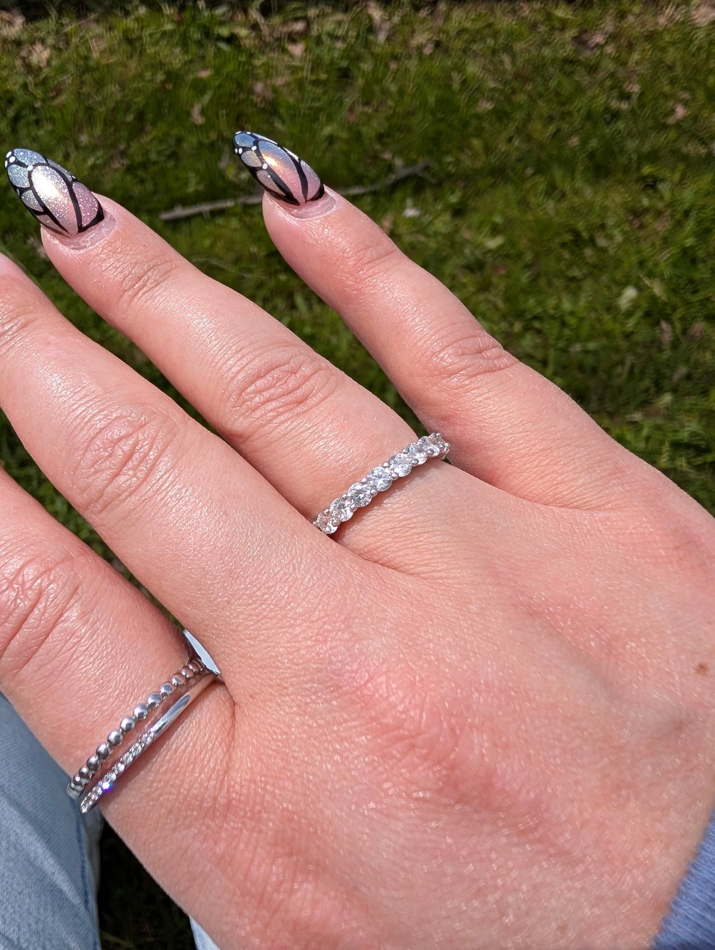 Freya Canada’s I AM ETERNITY Radiant zircon band ring on Freya muse Kynna worn on her ring finger in direct sunlight