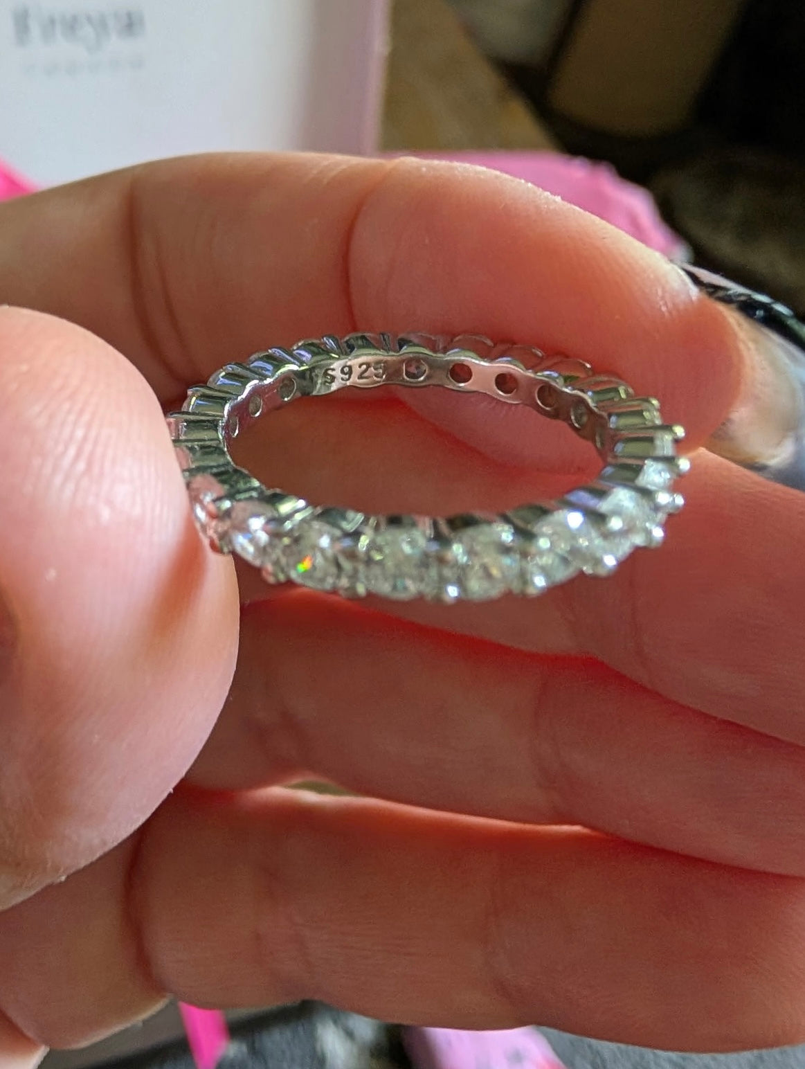 Freya Canada’s I AM ETERNITY Radiant zircon band ring being held up by Freya muse Kynna in natural lighting