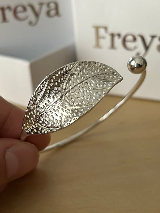 Model is holding the I AM ARTEMIS Wild One Leaf Bangle from Freya Canada. Ships from Vancouver BC. 